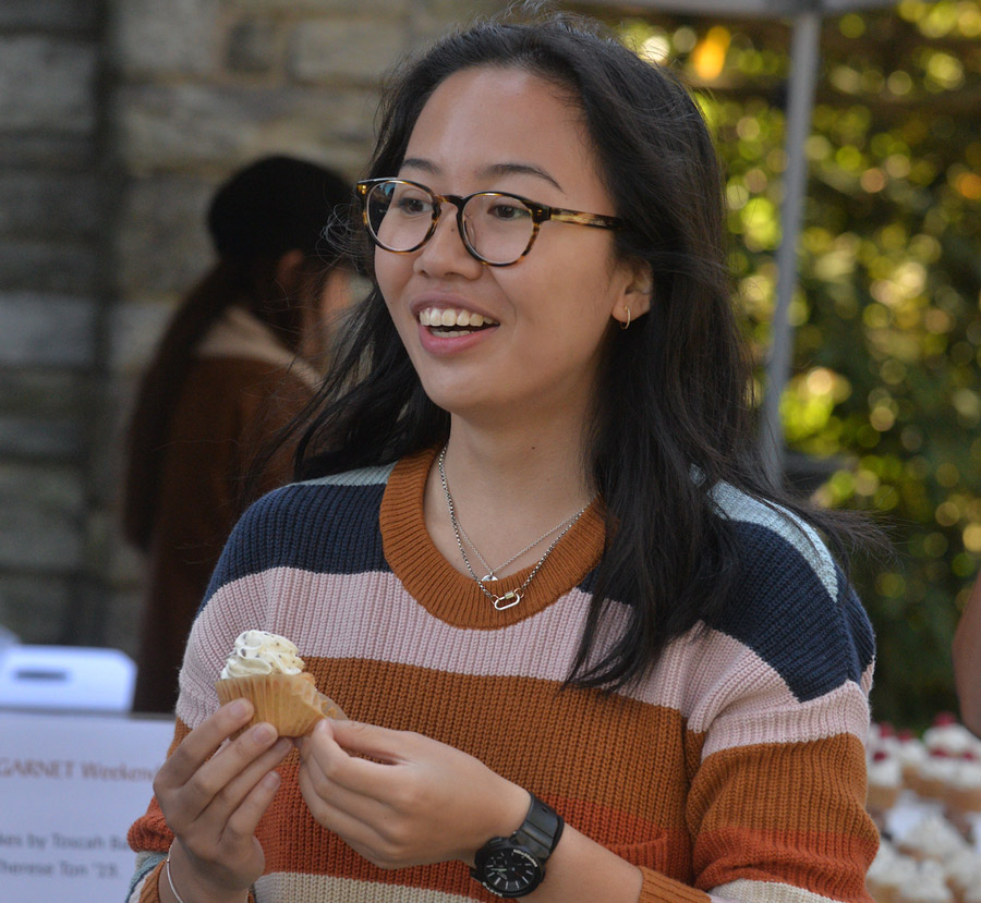 woman eating cupcake at event
