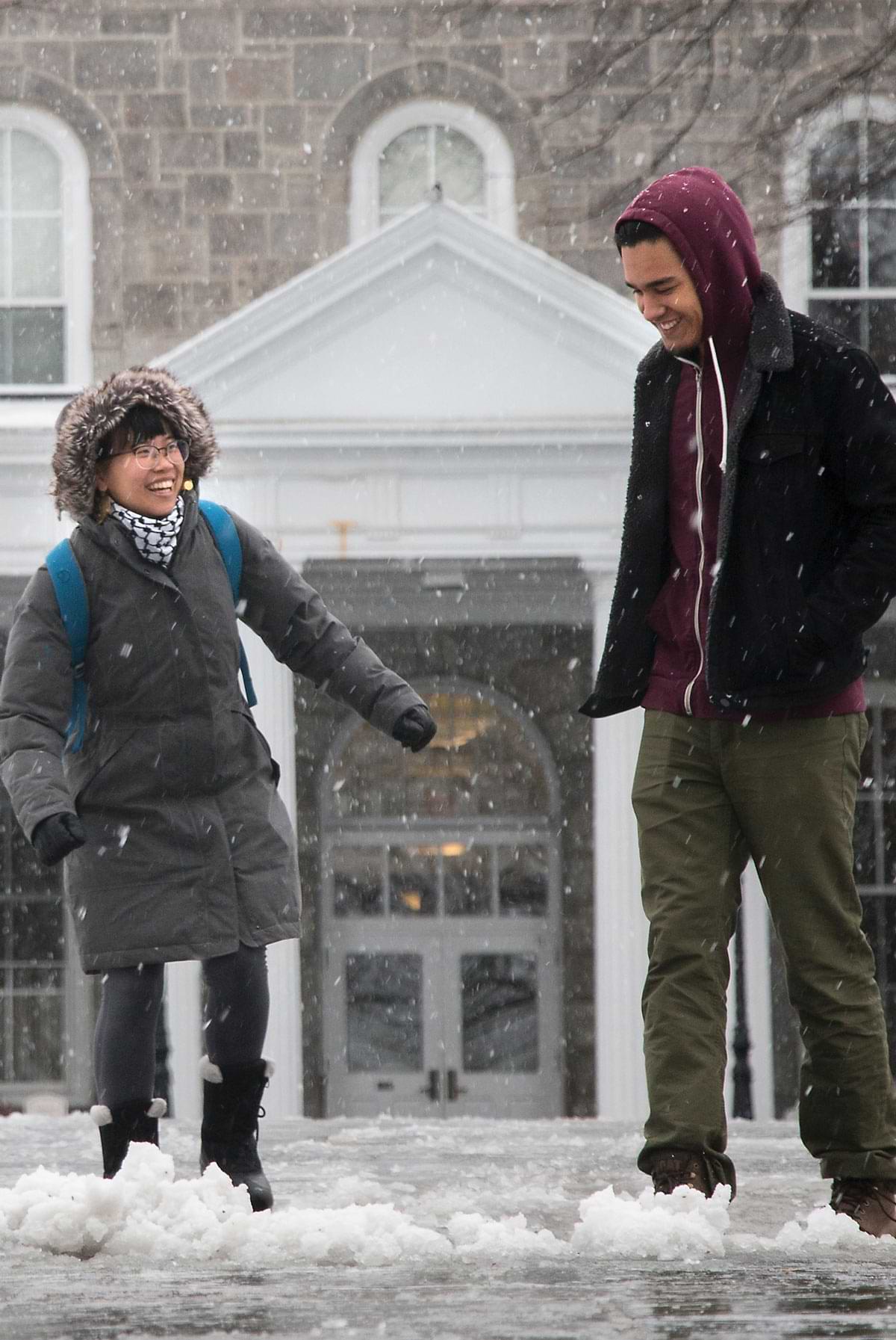 Two people walking in the snow