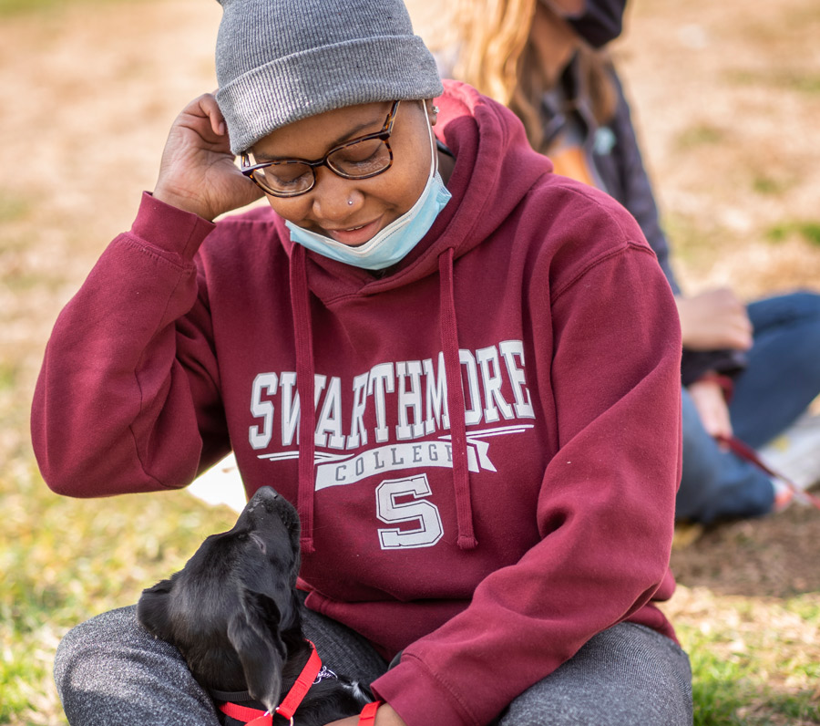 Swarthmore student playing with dog