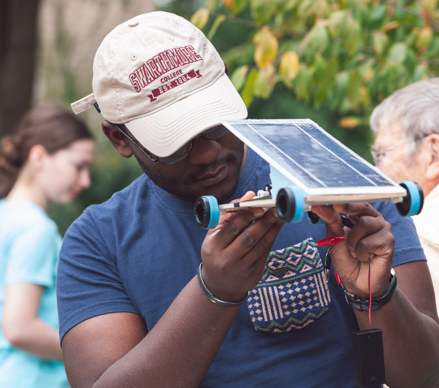 Swarthmore student inspects solar car