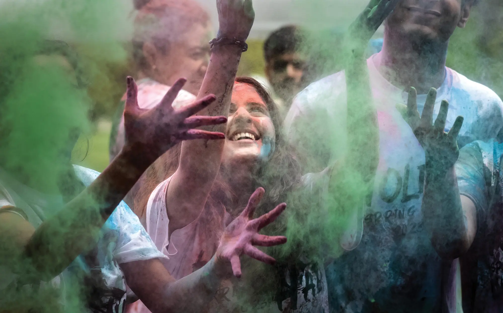 Students throwing up colored smoke