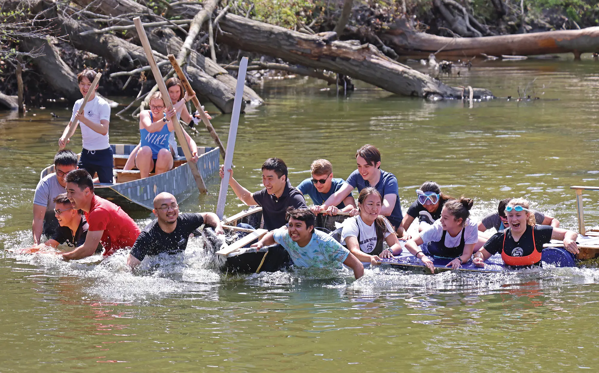 Students on boats, rafts and waking in a river