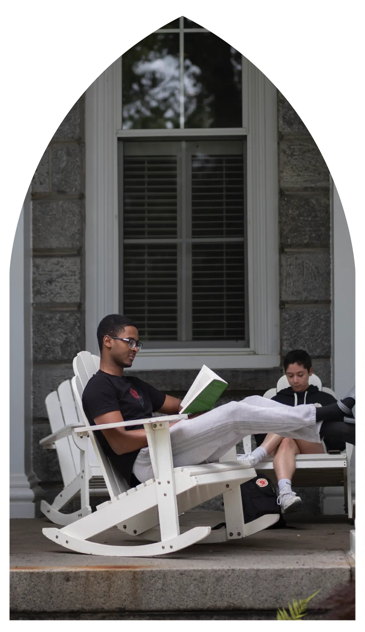 people reading books on a porch