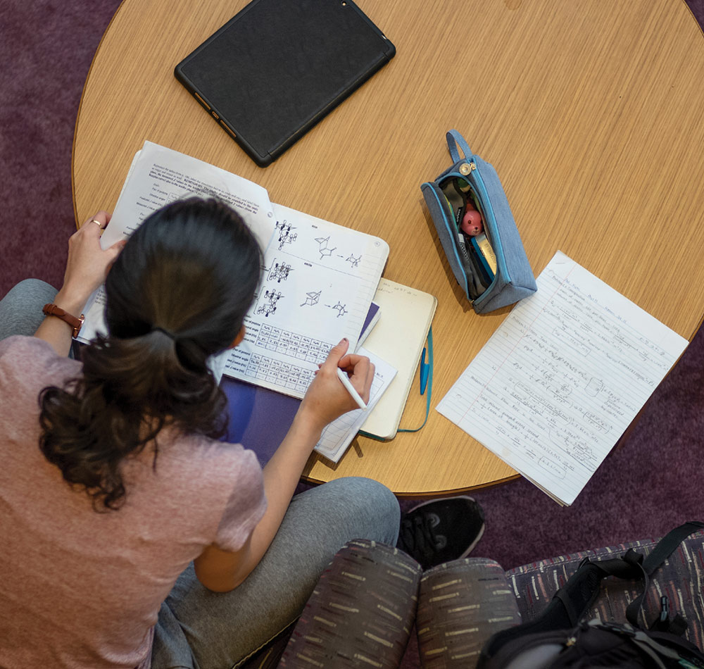 students doing work at a circular table