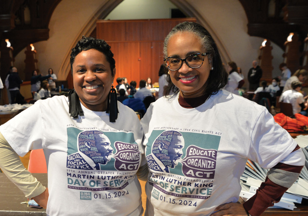 two women standing side-by-side wearing Martin Luther King Day of Service shirts