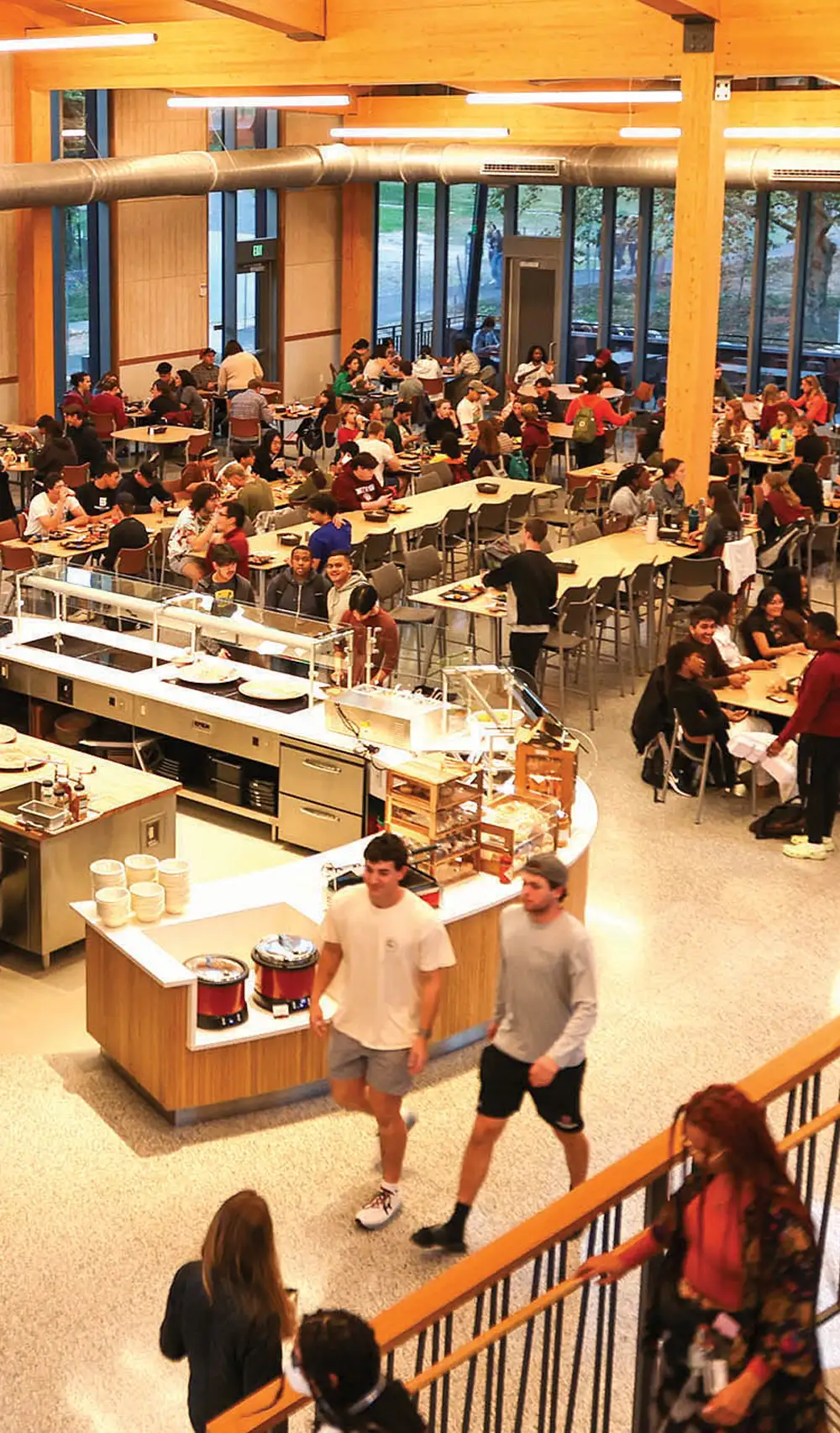 students eating and walking around a dining hall