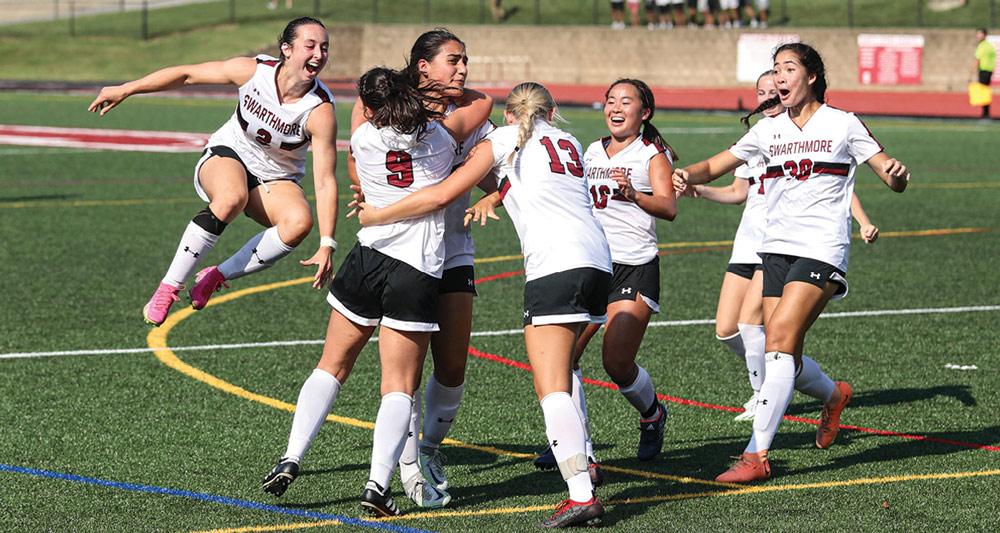 Swarthmore College women's soccer team celebrating on field